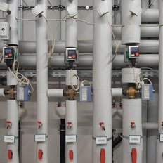 Komplexe Rohrleitungsanordnung mit mehreren Steuergeräten und Ventilen, die für die Prozesskontrolle verwendet werden.